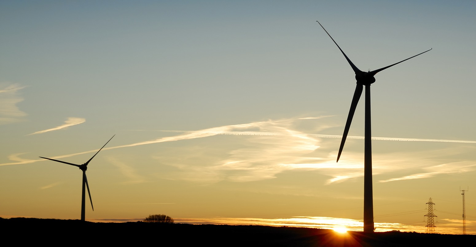 Sunrise behind a windfarm in Cornwall