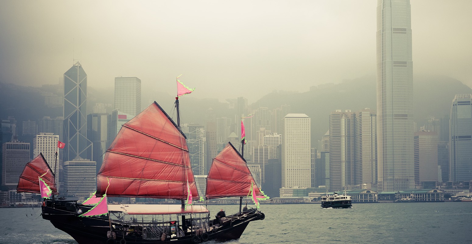 Traditional wooden sailboat sailing in victoria harbour ,Hong Kong.