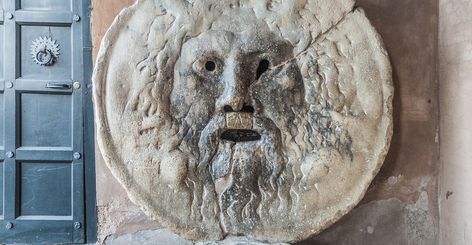 The Mouth of Truth carved from Pavonazzo marble, in the portico of the church of Santa Maria in Cosmedin in Rome, Italy