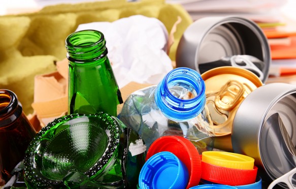 Recyclable garbage consisting of glass, plastic, metal and paper isolated on white background