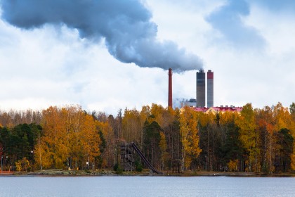 Air pollution from smoke coming from three factory chimneys