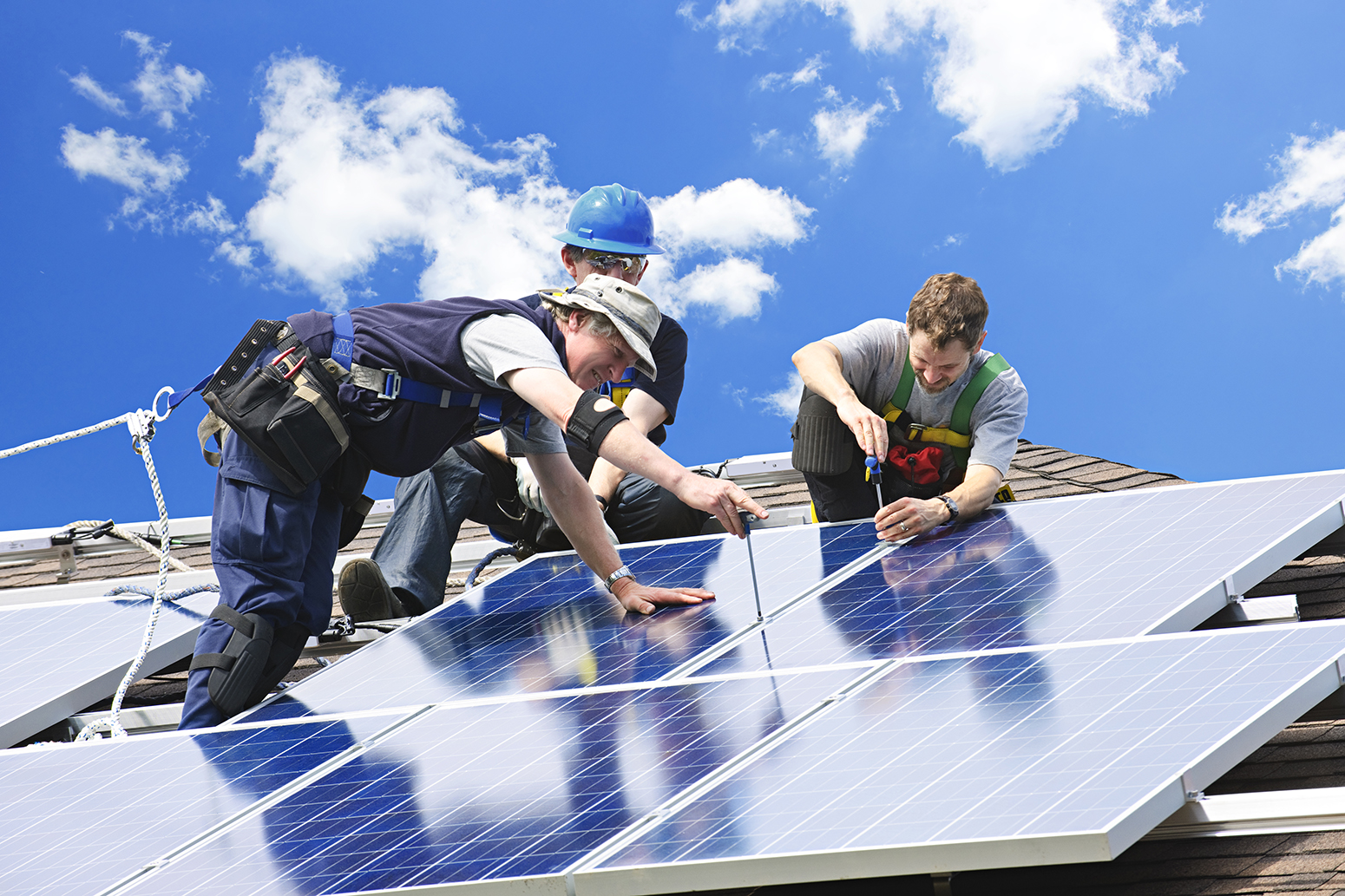 stock men installing solar panels roof | Carbon Brief