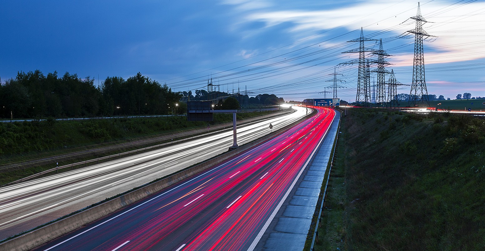 Light trails on a freeway with pylons in the background