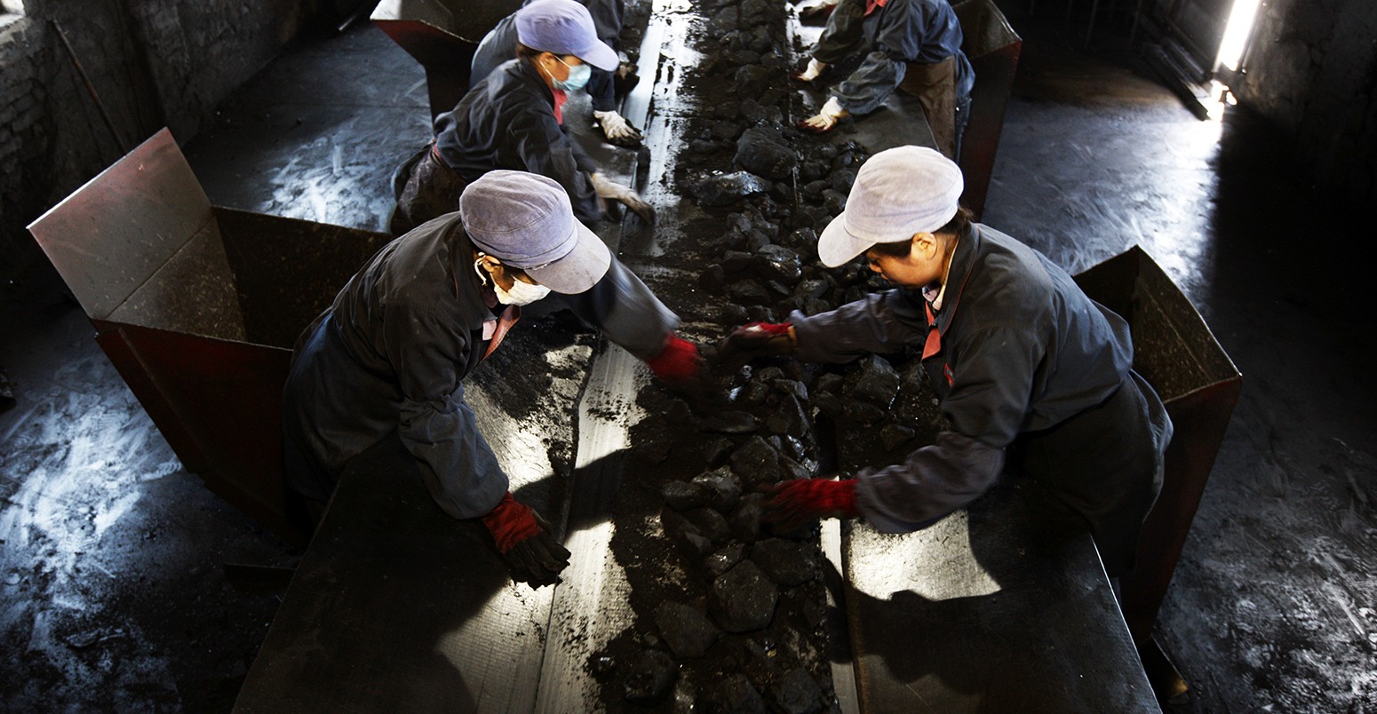 Chinese workers sort out waste rocks from coal