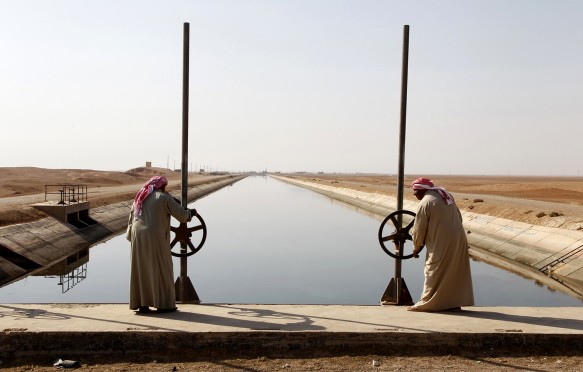 A view of a water canal running from the Euphrates river into the semi-desert region of eastern Syria