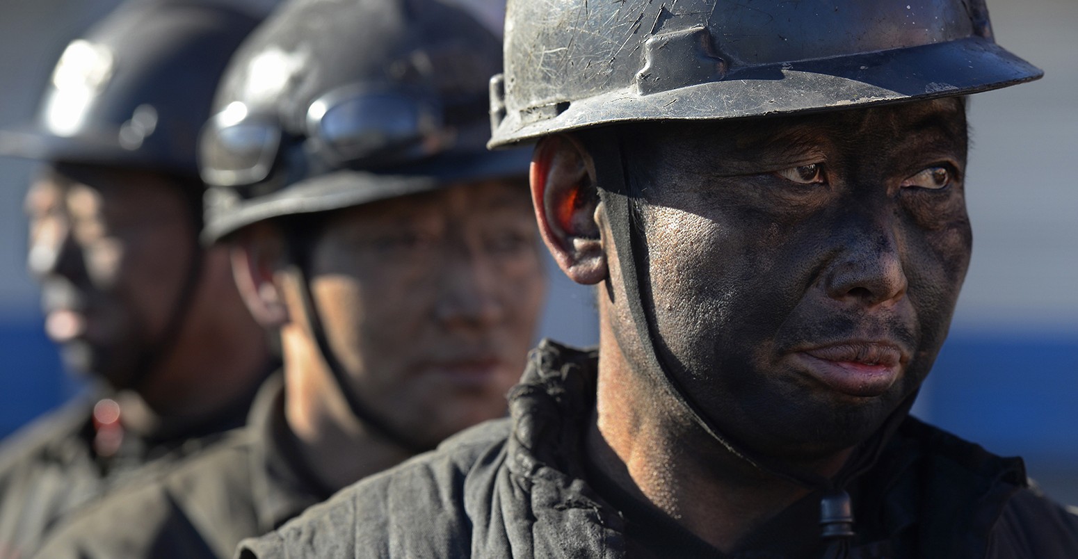 Miners wait in lines to shower during a break near a coal mine in Heshun county, Shanxi province