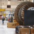 A worker walks past a gas turbine under construction at the gas turbines production unit of the General Electric plant in Belfort