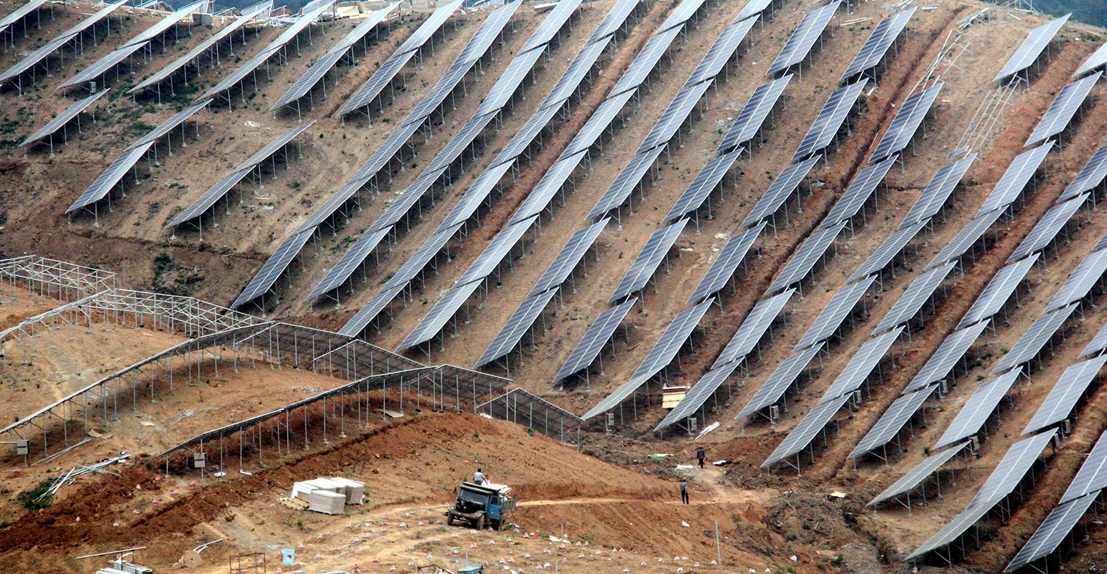 Chinese workers install solar panels at a photovoltaic power station in Eqiaotown, Wuhu city, east China's Anhui province