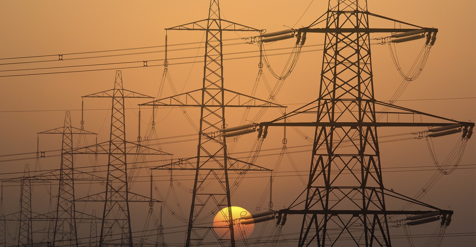 Electricity pylons at sunset in Radley Village, Oxfordshire England