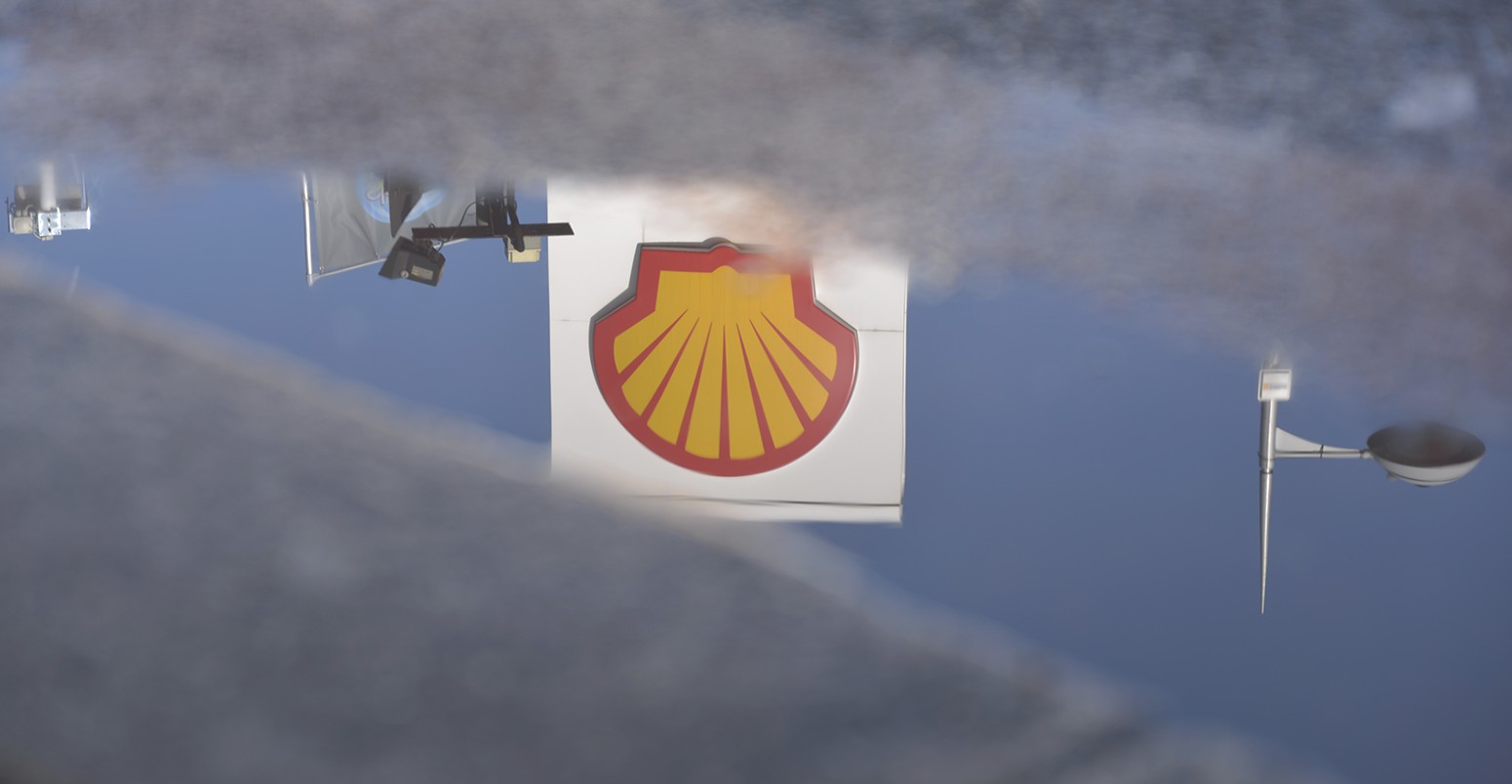 A puddle reflecting the Royal Dutch Shell company logo