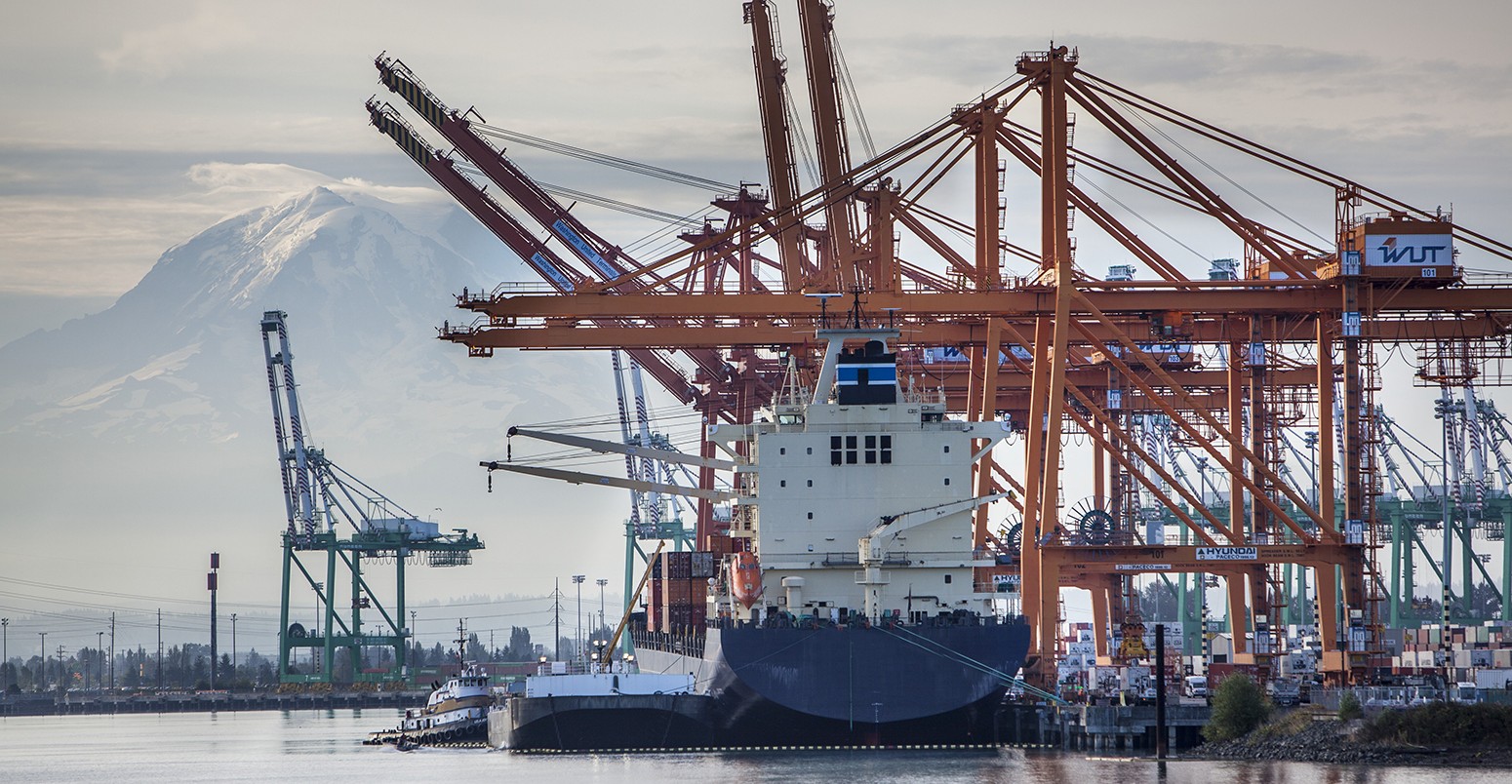 Commercial loading docks and cranes as viewed from harbor