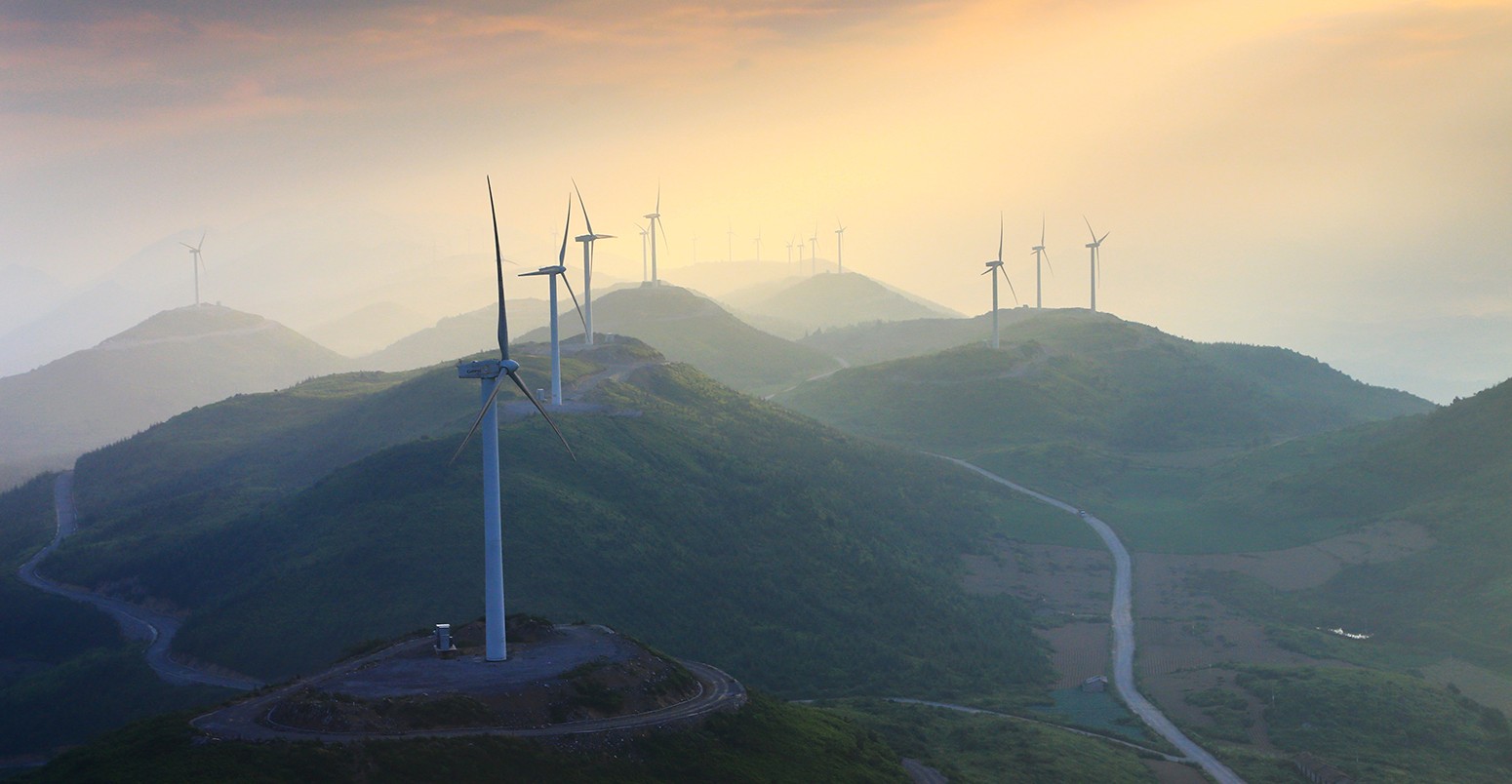 Wind turbines whirl to generate electricity at the Wangying Wind Farm in Lichuan city, central Chinas Hubei province