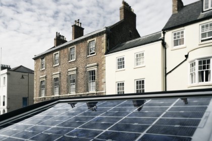 The solar panel of a parkmeter reflects the sky in a street of Durham, England.