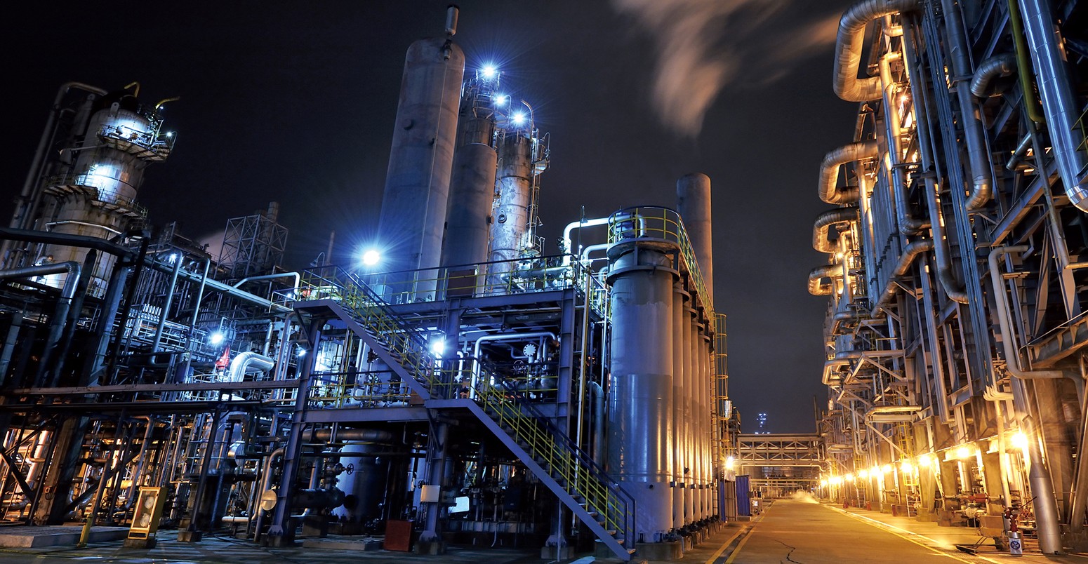 Oil refinery, chemical and petrochemical plant at night.