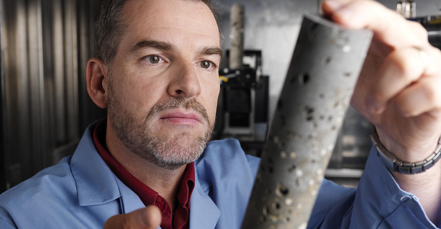 Scientist examines a basalt core sample