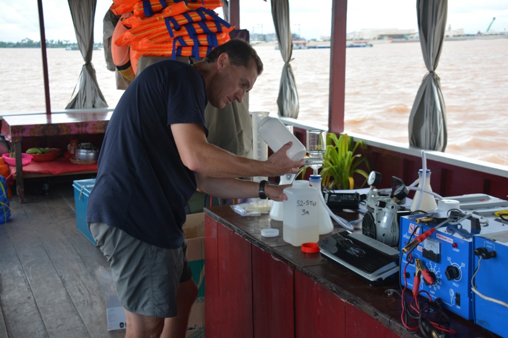 Prof Steve Darby processing suspended sediment samples on board the RV Stelar, a converted tourist boat on the Mekong river. Credit: Prof Jim Best