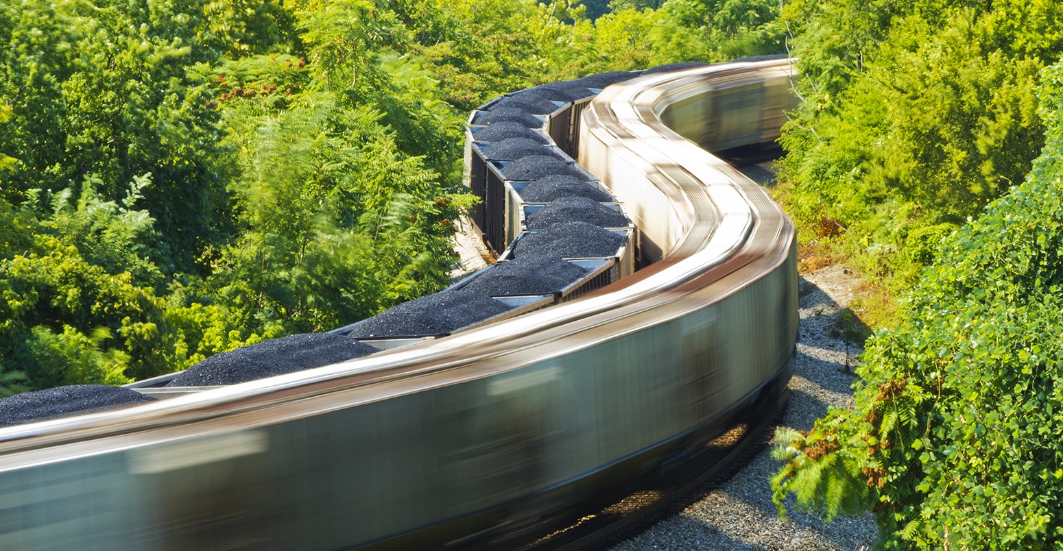 Stationary coal train is passed by a freight train , Virginia, US