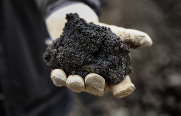 A handful of black oil rich sand from Alberta Canada.