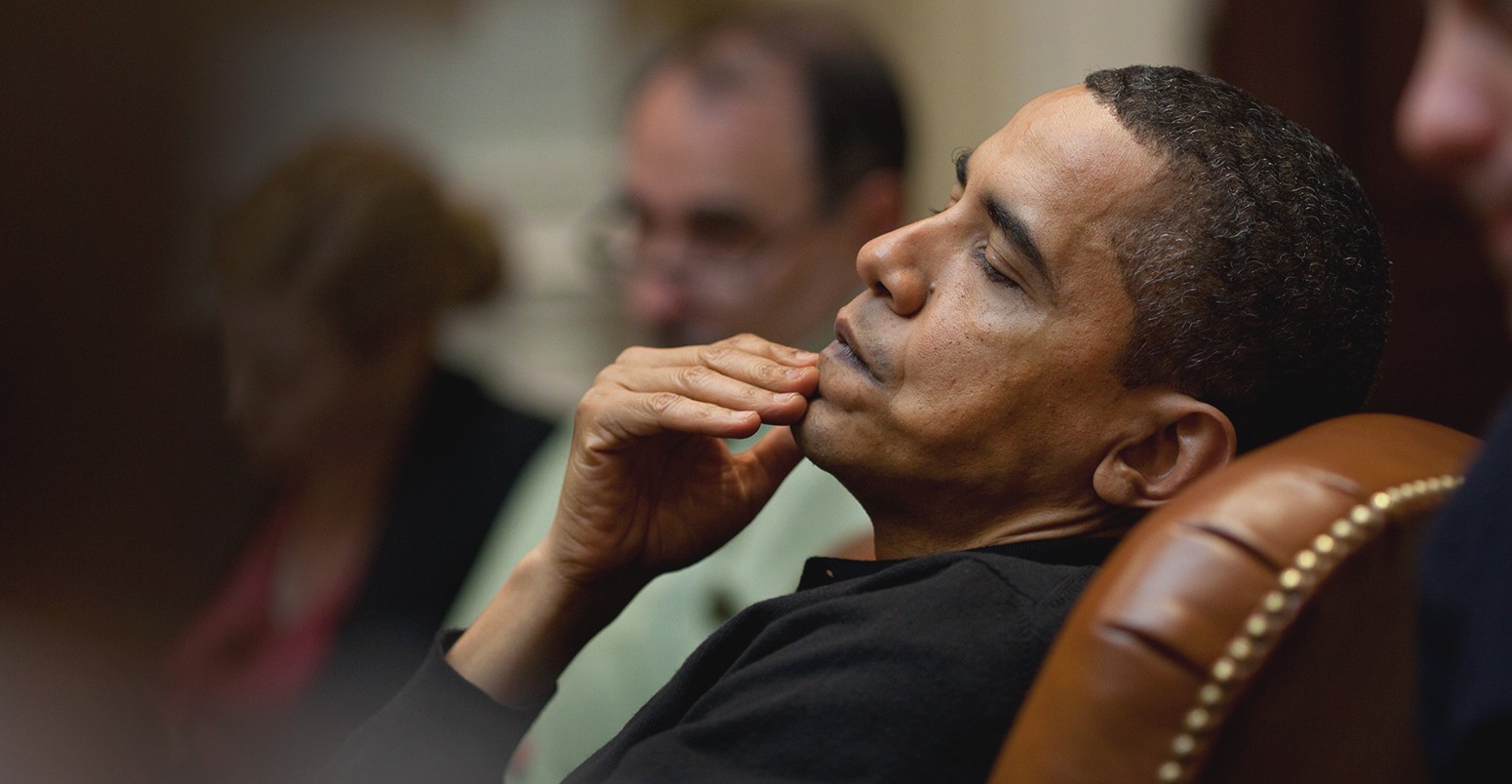 President Obama reflects during an economic meeting with advisors in the Roosevelt Room. He is seated between Senior Advisor David Axelrod and Chief of Staff Rahm Emanue