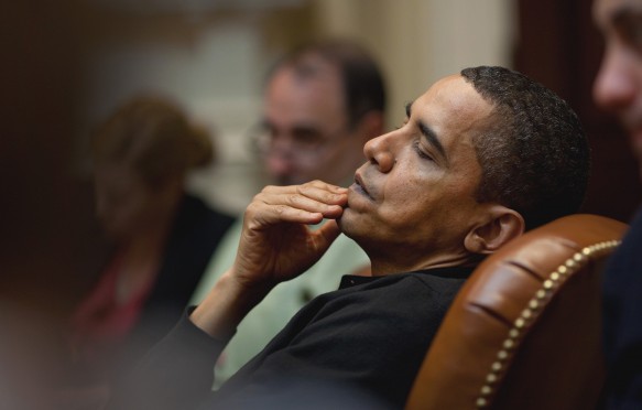 President Obama reflects during an economic meeting with advisors in the Roosevelt Room. He is seated between Senior Advisor David Axelrod and Chief of Staff Rahm Emanue