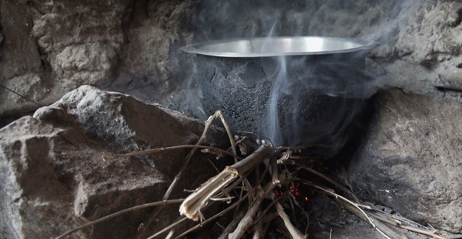 James Okeyo cooks dinner on his three stone cook stove in Kisumu, Kenya. The EnDev Kenya Country Programme is helping to replace these three older charcoal stoves with cleaner, less smoky wood burning stoves. Up to December 2015, 87,000 households have switched to the improved, cleaner burning jiko kisasa (firewood stove).