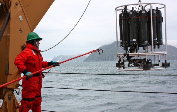 Holley Kelly helps retrieve the CTD/Rosette ensemble from the Bering Strait, east of the Diomede Islands, June 2011
