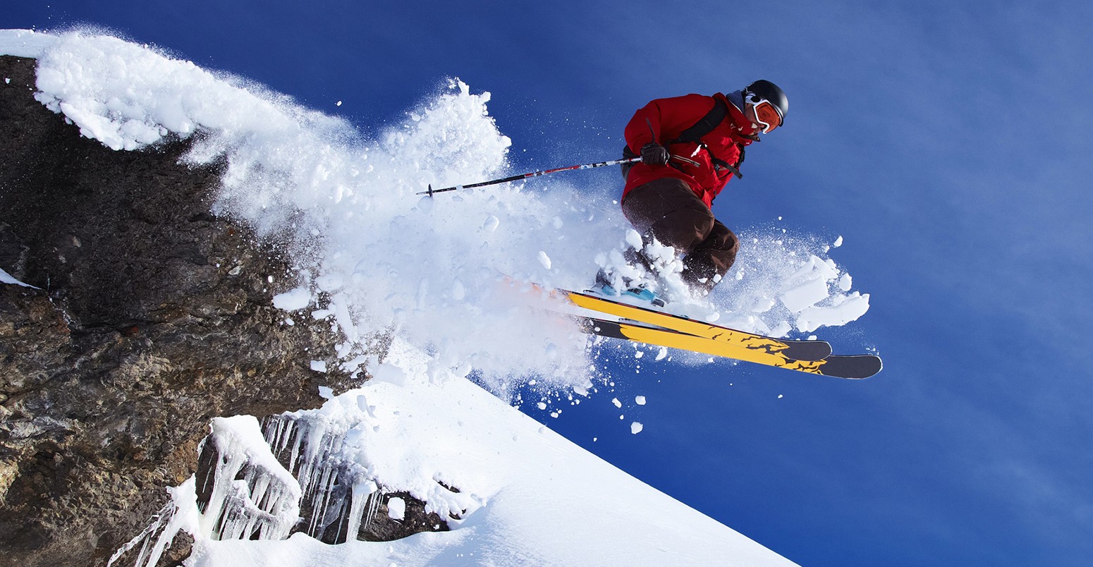 Skier jumping on snowy slope in Switzerland