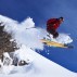 Skier jumping on snowy slope in Switzerland