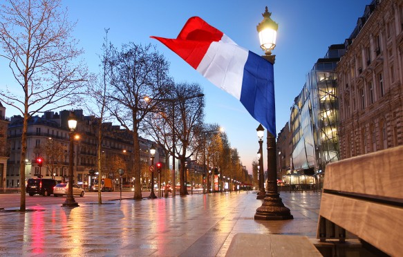 Flag flying in the Paris Champs Elysee street in the evening