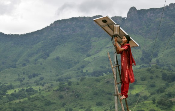 Meenakshi Dewan tends to maintenance work on the solar street lighting in her village of Tinginaput, India.