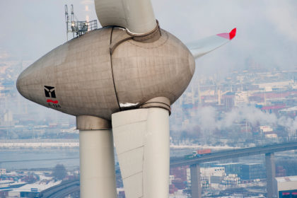 Enercon wind turbine E-126 with 6 MW in harbour and view on Hamburg City