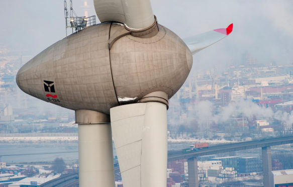 Enercon wind turbine E-126 with 6 MW in harbour and view on Hamburg City