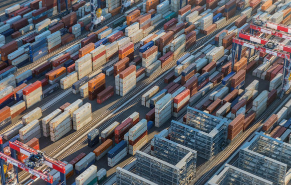 Afternoon aerial view of cargo shipping containers stacked on docks, in Los Angeles, US, 18/08/2016