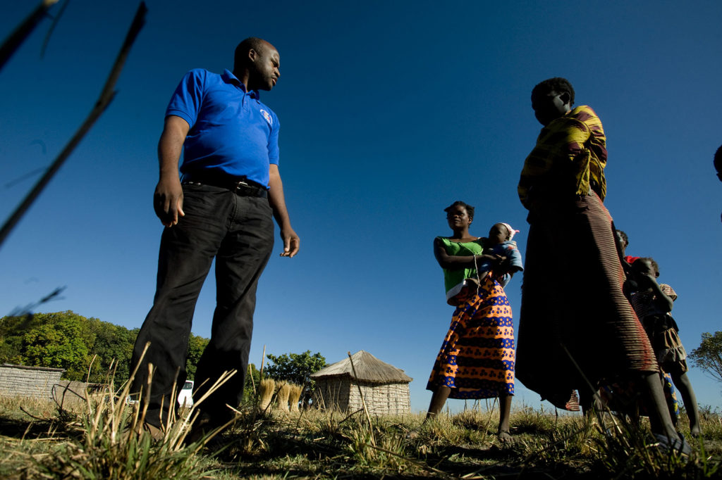 Akabondo Mainais, left, the monitoring and evaluation officer for the Climate Investment Fund (CIF) projects in western Zambia. He talks here to the Nalunau family, who have been farming here for 3 generations. They explain that they are struggling because the flood waters on the Barotse plain are not receding like they used to. CIF is supporting projects within the Pilot Project for Climate Resilience in Zambia. The largest plain the in the country is the Barotse Sub Basin, in the country's far western half.