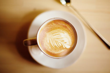 Latte coffee art. Vintage color effect, top view. Selective focus