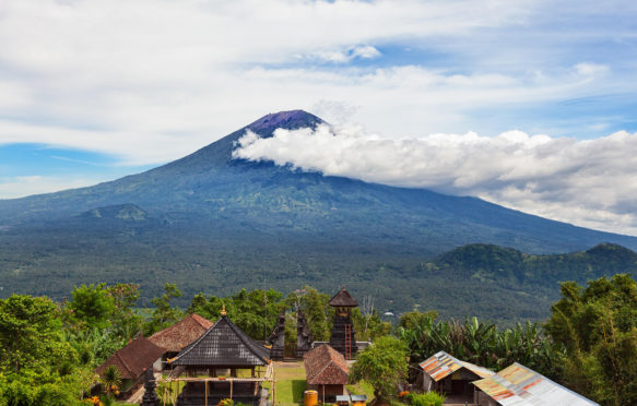 K9NHH6 View from Lempuyang mountain to traditional Balinese temple on Mount Agung slopes background. Mount Agung is highest active volcano on Bali island.