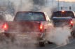 B7T95A Auto emissions- tailpipe exhaust from cars driving in town, waiting in traffic at an intersection. Image shot 2009. Exact date unknown.