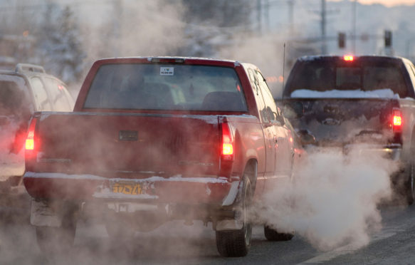 B7T95A Auto emissions- tailpipe exhaust from cars driving in town, waiting in traffic at an intersection. Image shot 2009. Exact date unknown.