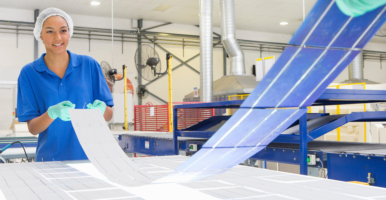 EYYW0B Technicians arranging solar cells to form solar panel on factory production line