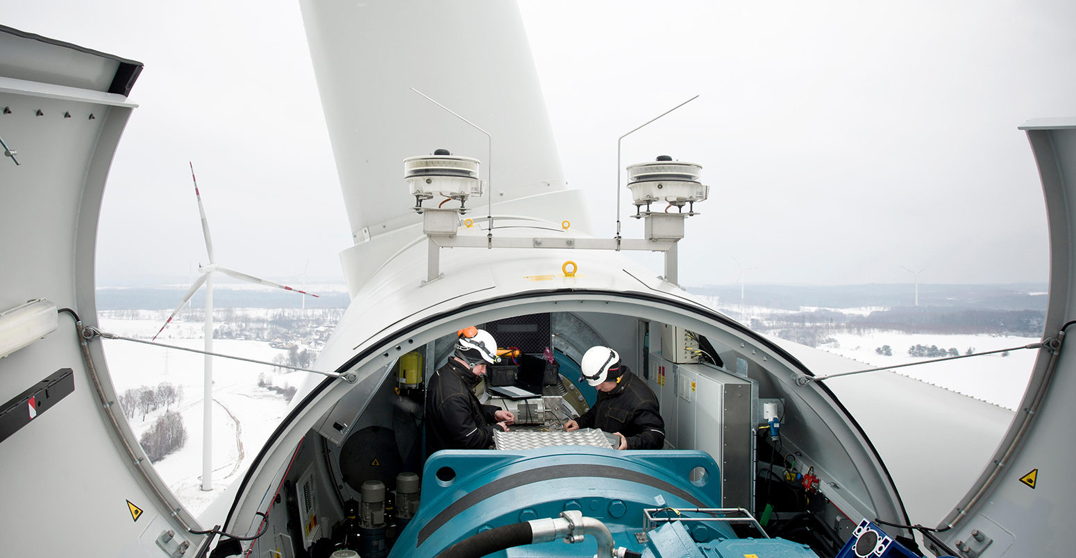 EM6TE7 Two maintenace men work on a wind turbine in northern Poland near Kobylnica during the winter.