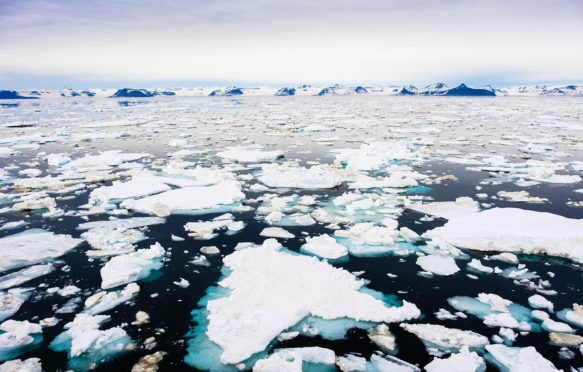 KDX99H Offshore view across sea ice floe to mountains on east coast at 2 am in arctic summer. Spitsbergen island, Svalbard archipelago, Norway, Scandinavia.