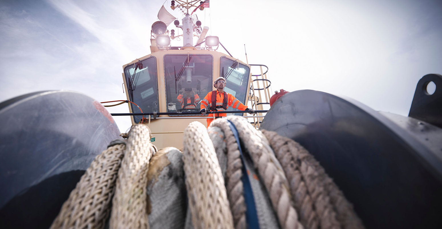 CYKY1Y Tugboat worker standing on bridge