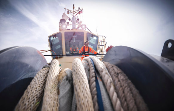CYKY1Y Tugboat worker standing on bridge