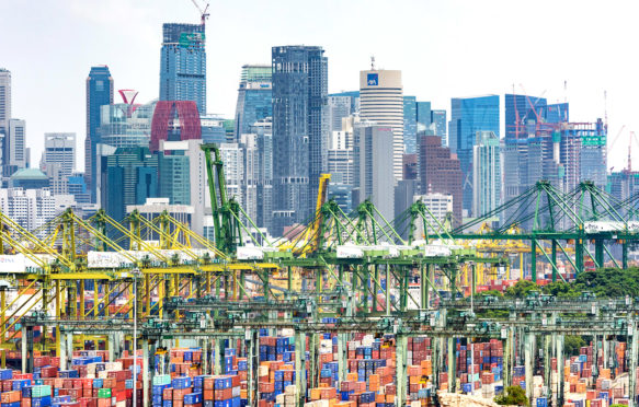 PSA International Brani Container Terminal with the CBD skyline, Brani Island, Singapore. Credit: Jason Knott / Alamy Stock Photo. FGRPBF