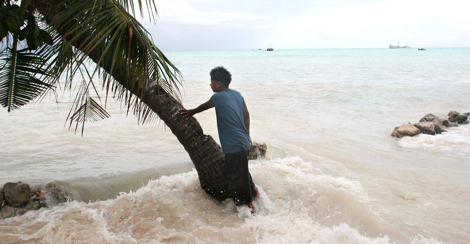 King tides flood property on Kiribati atoll. Credit: Jeremy Sutton-Hibbert / Alamy Stock Photo. BGP1PD