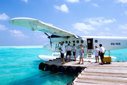 Passengers boarding a sea plane Maldives Indian Ocean. Credit: Sunpix Travel / Alamy Stock Photo. AKAWF0