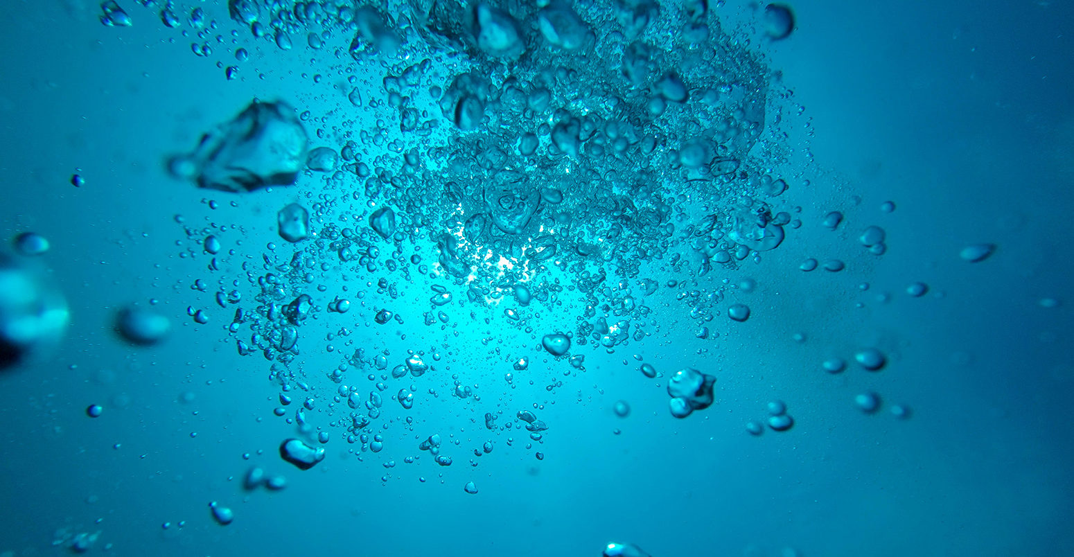 EYTY14 Air bubbles floating up through blue sea water, Galapagos Islands, Ecuador 2015.
