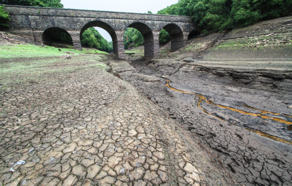 PAGGF2 Lancashire, UK. 21 July 2018. The Reservoir is now showing very low levels due to a sustained dry period, and is shown here after 2 days of rain. United Utilities who own the reservoir intend to introduce a hosepipe ban from 5 August 2018. The reservoir supplies Liverpool via a series of reservoirs in the Rivington area, which were recently used to supply water for helicopters fighting the Winter Hill fires. The bridge shown is the Alance Bridge, which spans the River Yarrow, which would normally flow through it into the reservoir. Credit: Phil Taylor/Alamy Live News