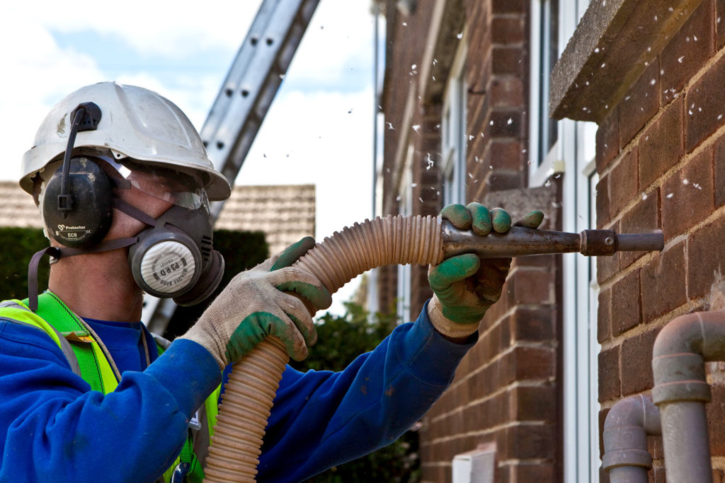 Cavity wall insulation being installed in a home in Kirklees, UK. Credit: Andrew Aitchison / Alamy Stock Photo. BR5W45