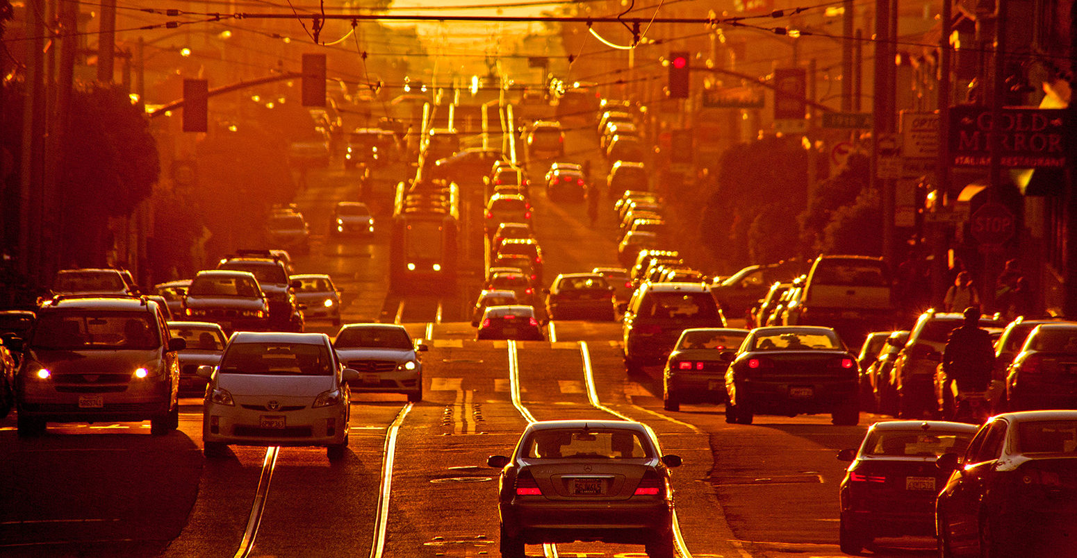 Setting sun shines on afternoon traffic on Taraval Street in San Francisco. Credit: MarmadukeSt. John / Alamy Stock Photo. DR8AK8